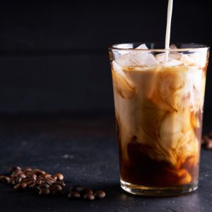 Cold ice coffee with milk in glass