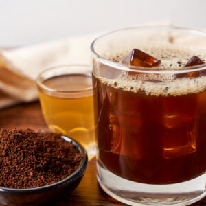 Popular cocktail called carajillo made with espresso, liquor and ice on a wooden table.