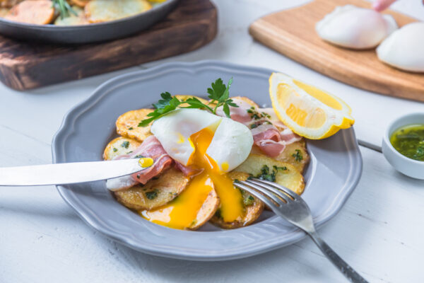 Running eg yolk on poached eg over potato and jamon