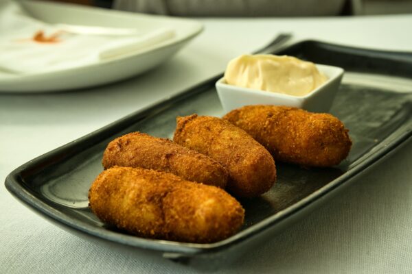 Spanish cover. Delicious gourmet croquettes stuffed with Iberian ham.Famous spanish tapa.