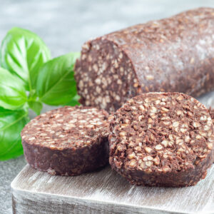 Traditional Irish and British black pudding sausage slices on a wooden board, horizontal