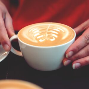 Woman drinks coffee with milk.