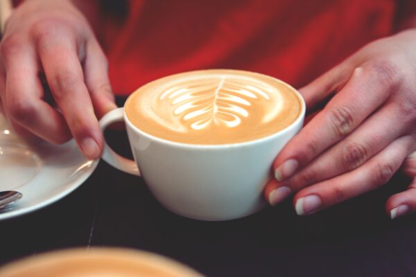 Woman drinks coffee with milk.